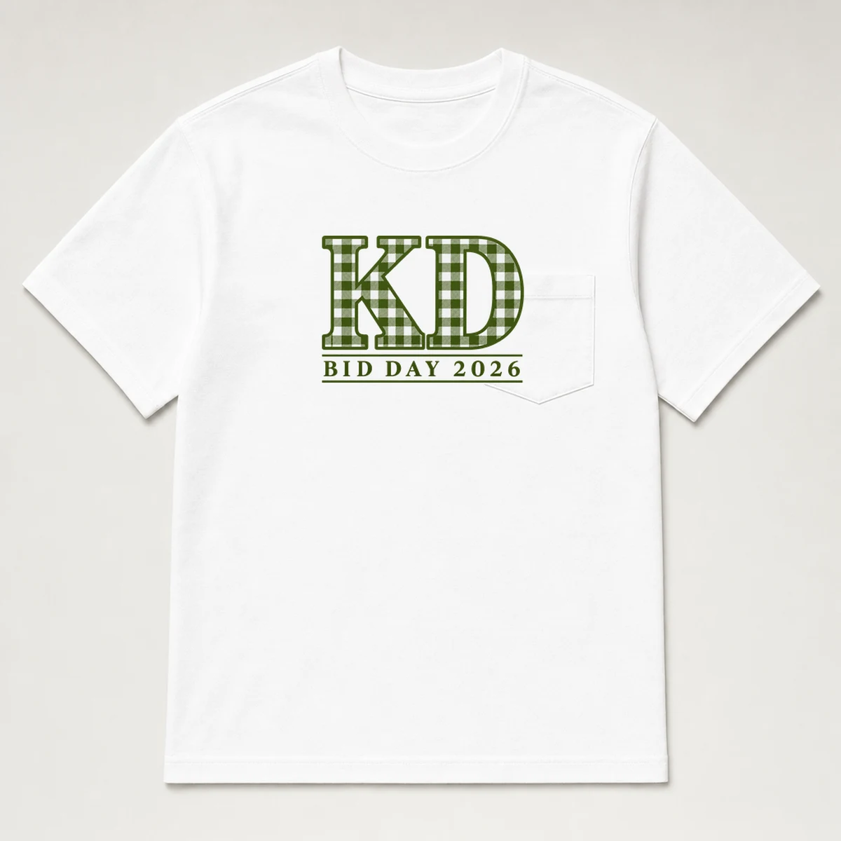 front view of a white pocket tee with stacked KD letters and a bid day 2026 line