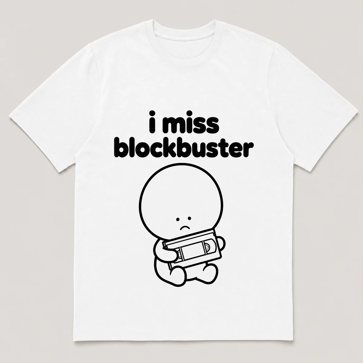 lonely boi tee: a small sad cartoon boy hugging a vhs tape in a rental case, with the words i miss blockbuster above him