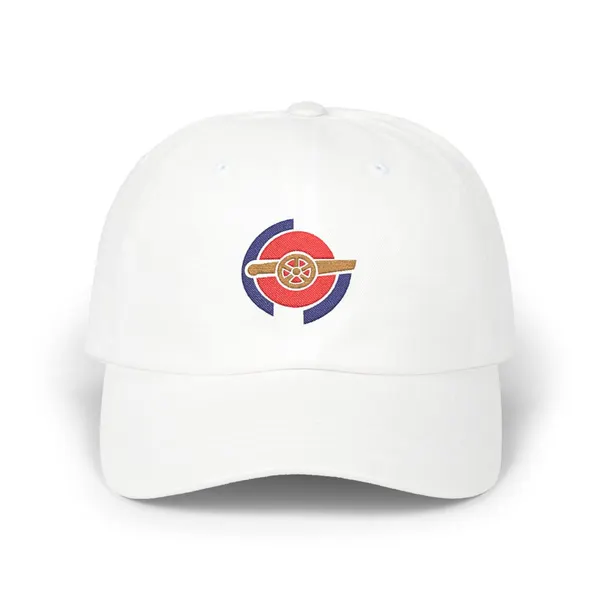 Abstract embroidery in red, navy, and old gold, composed of flat geometric shapes on a cap panel.
