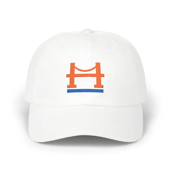 Embroidered abstract geometric shapes in bright orange and royal blue on a neutral fabric background.
